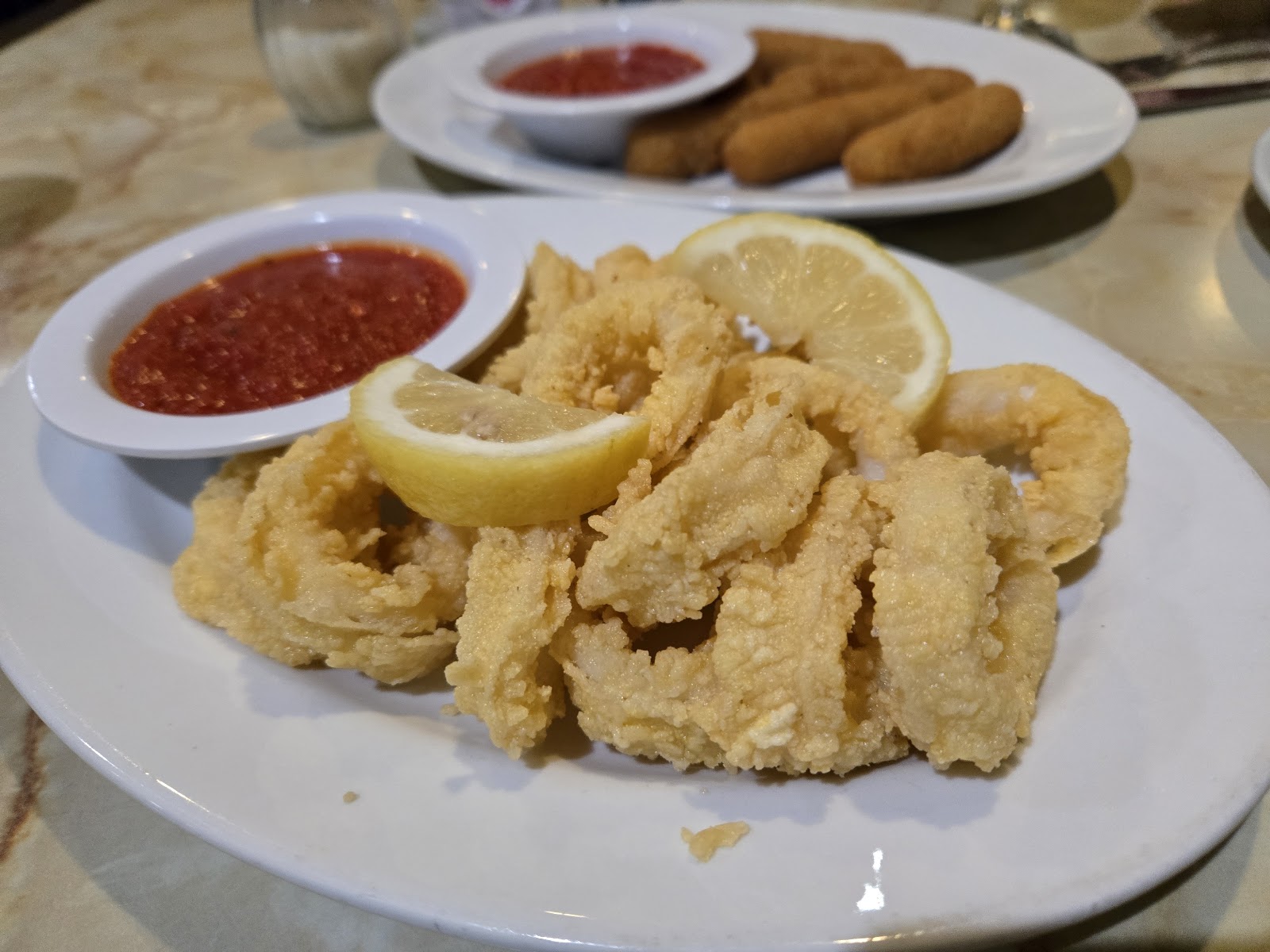Crispy fried calamari served with marinara and lemon